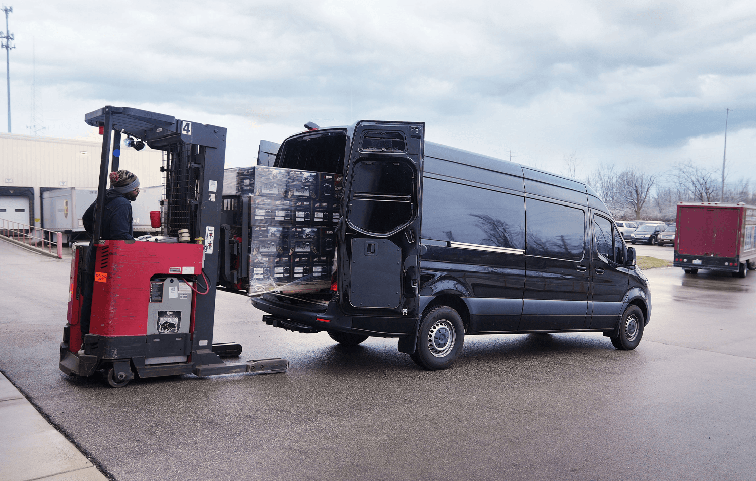 A forklift loading a Mercedes Sprinter 2500 van with LoadLifter 5000 load support kits fit for the vehicle.